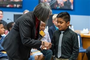 Josue accepting award from Superintendent Moore